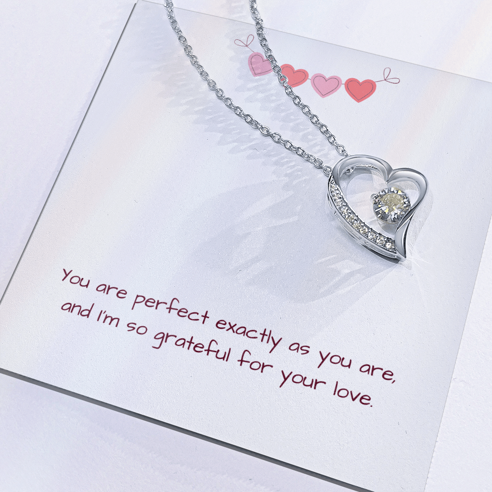 Close-up of silver Perfectly You Heart Necklace in gift box with loving message