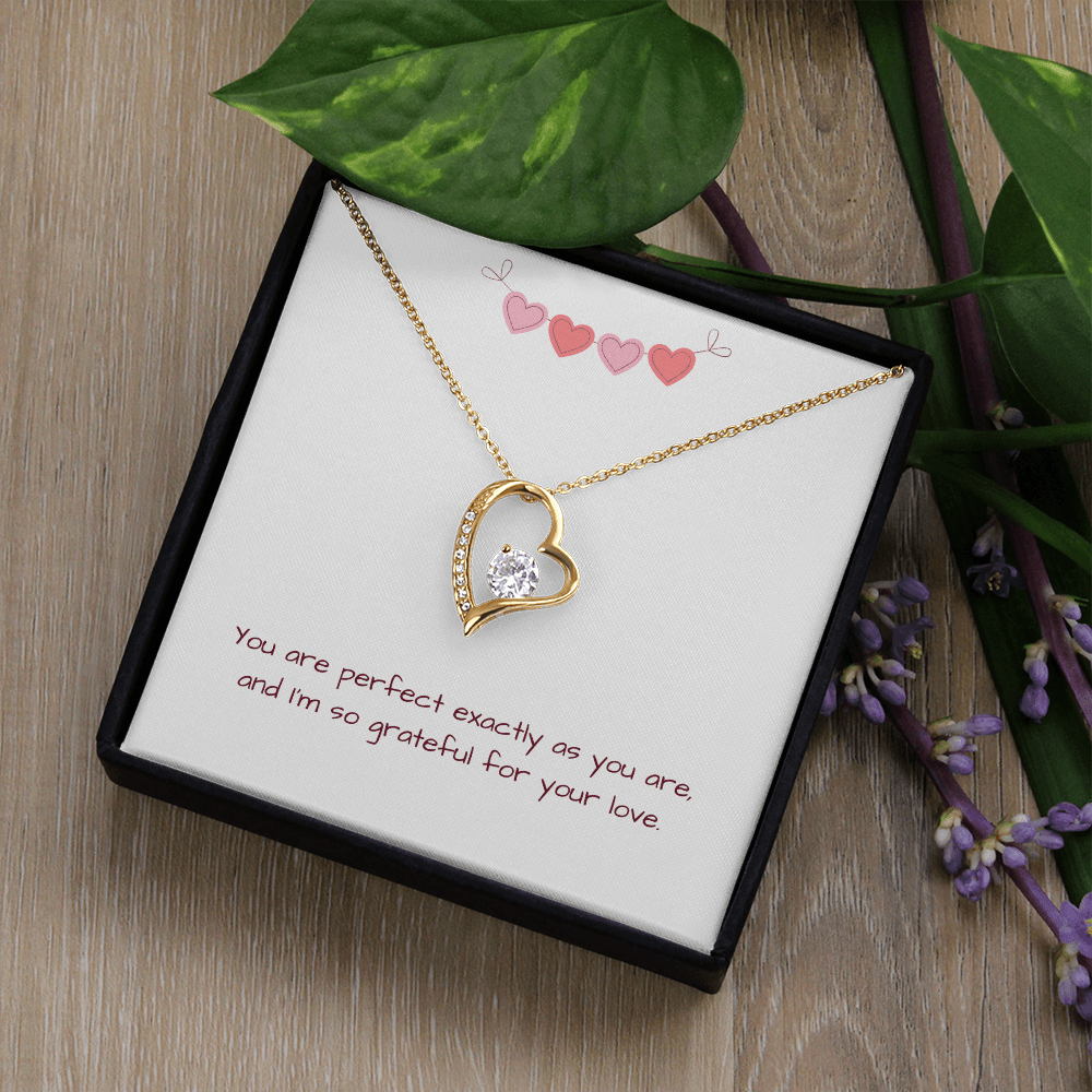 Gold Perfectly You Heart Necklace shown in black box with pink hearts and message